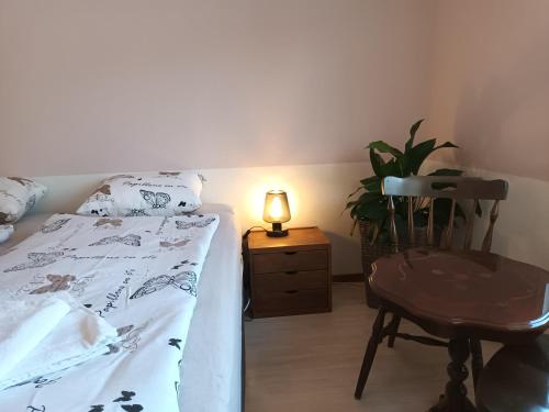 a bedroom with a bed and a chair and a lamp at Dals Långeds B&B in Dals Långed