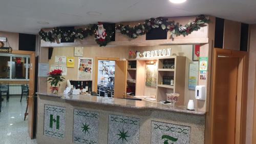 a bar in a restaurant with christmas decorations at Hostal Fronton in Alcobendas