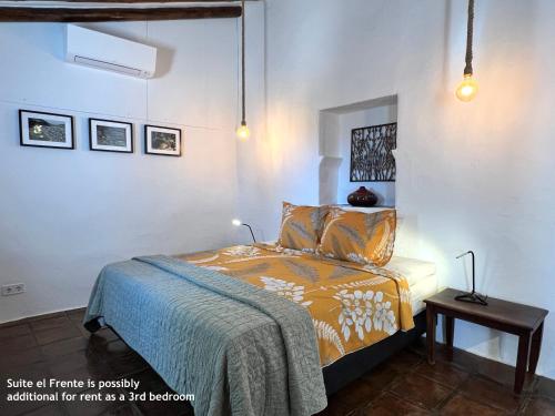 a bedroom with a bed and a side table at Casita Zayas - Guesthouse in Periana