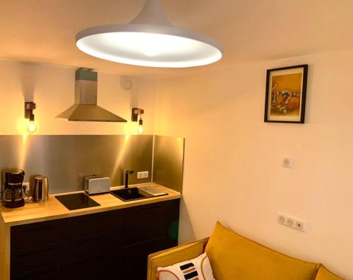 Pokój z kuchnią ze zlewem i lampką w obiekcie Studio cosy en plein centre historique de Rennes w mieście Rennes