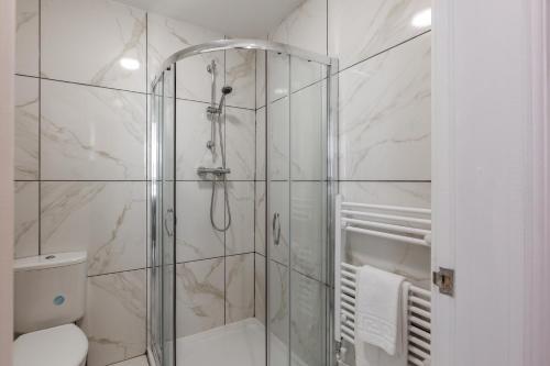 a bathroom with a glass shower with a toilet at York Villas Free Parking Included in Liverpool