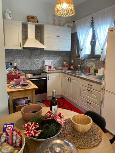 a kitchen with a table with a bottle of wine at Stellas guesthouse near Arachova in Stírion