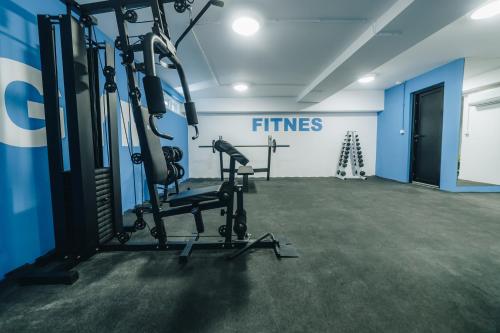 a gym with two tread machines in a room at LUST PREMIUM Apartments in Kragujevac