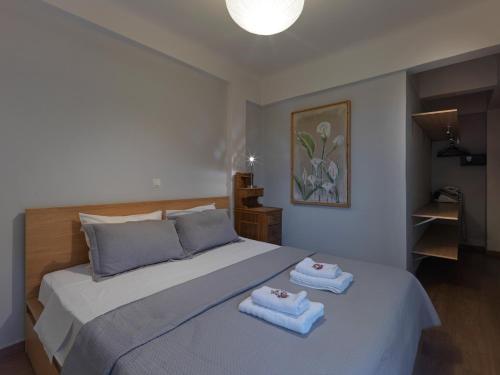 a bedroom with a bed with two towels on it at Luxurious Top Floor Acropolis View Loft in Plaka - Newly Refurbished in Athens