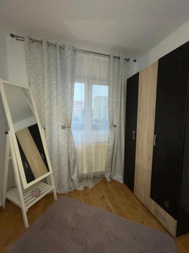 a room with a window with a ladder and a shelf at BUTTERFLY FAMILY APARTMENT SIBIU in Sibiu