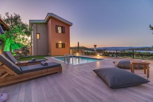 a backyard with a swimming pool and a house at Seaview Villas in Vourvourou