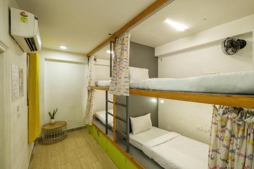 a small room with bunk beds in a dorm at Moustache Hostel, Jaipur in Jaipur