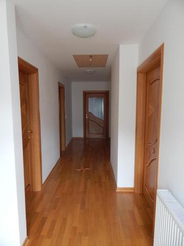 an empty hallway with wooden floors and doors at Rooms Ambrožič in Bled