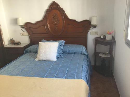 1 dormitorio con 1 cama con cabecero de madera en CASA DIEGO y JOSEFINA, en Rus