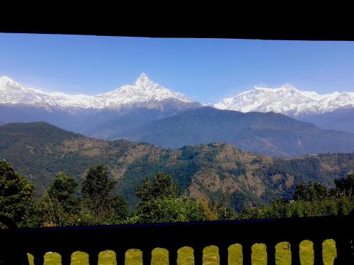 a view of a mountain range with snow capped mountains at Himalayan Deurali Resort in Pokhara