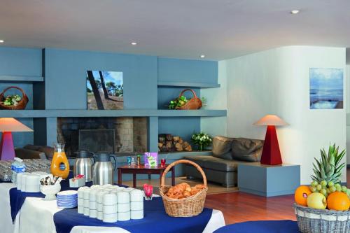 a living room with a table with fruit on it at Hotel Belambra Le Normont in Dourdan