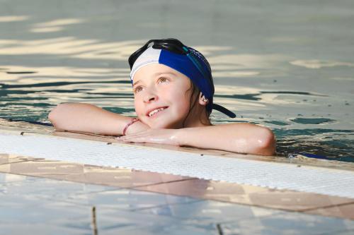 a young woman swimming in a swimming pool at The Lakeside Hotel & Leisure Centre in Killaloe