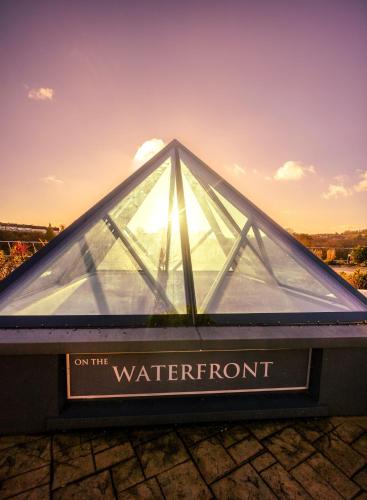 a glass pyramid building with the sun shining through it at The Lakeside Hotel & Leisure Centre in Killaloe