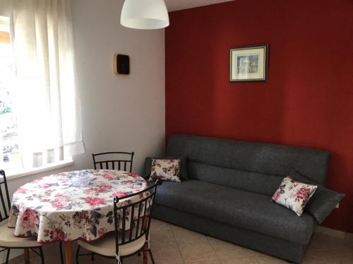 un soggiorno con divano e tavolo di Apartment in Lovran with terrace, air conditioning, WiFi, washing machine 3735-1 a Lovran (Laurana)