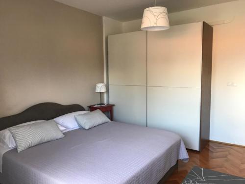 una camera con un grande letto e una lampada di Apartment in Lovran with terrace, air conditioning, WiFi, washing machine 3735-1 a Lovran (Laurana)