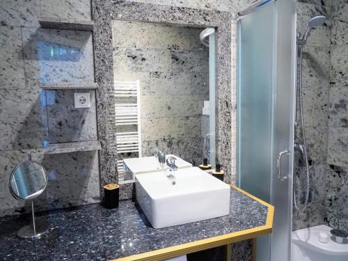 y baño con lavabo y espejo. en City Villa Schönbrunn Apartments - Contactless 24h Check-In, en Viena