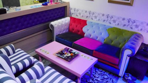 a room with a colorful couch and a table at Captain's Beach Apartments in Limenas