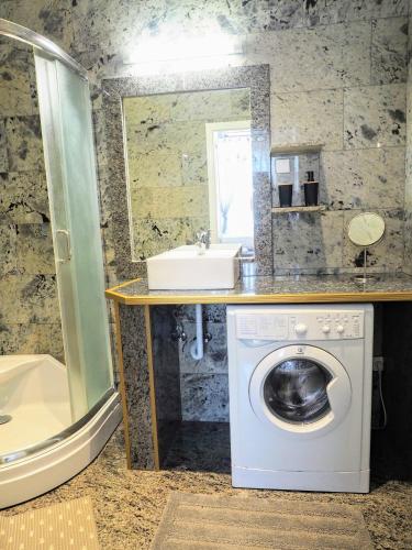 a bathroom with a washing machine and a sink at City Villa Schönbrunn Apartments - Contactless 24h Check-In in Vienna