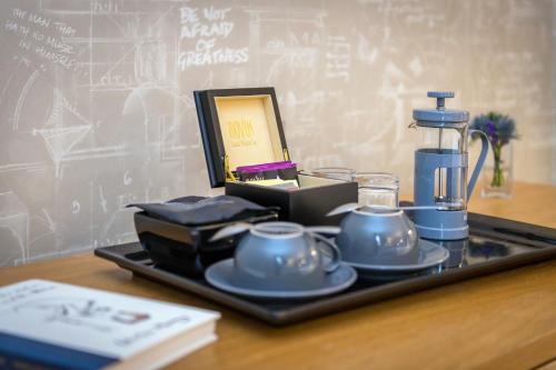 a tray with tea cups and a blender on a table at The Scholar in Edinburgh
