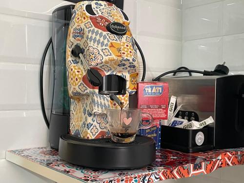 a coffee maker on a counter next to a microwave at Home4Apartment in Salerno