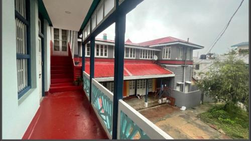 a view from a balcony of a building with a red door at Solan Retreat in Solan