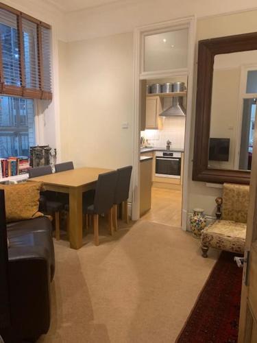 a kitchen and dining room with a table and chairs at Central London (West End) two bedroom flat in London