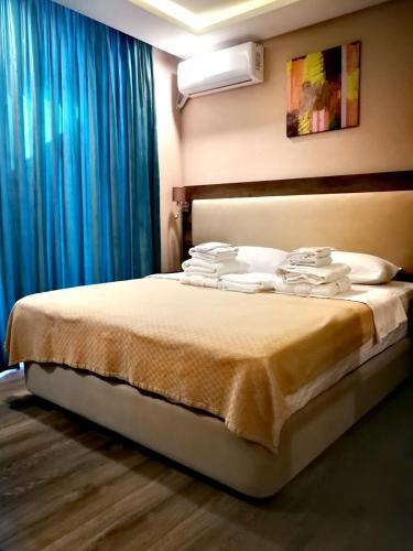 a bedroom with a bed with towels on it at Luxury Hotel Suite Apartment in Batumi