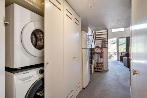 a laundry room with a washer and dryer at Squatters Run Unit 11 in Thredbo