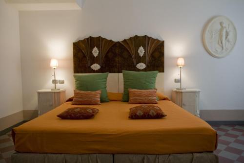 a bedroom with a large bed with two lamps at Art Hotel Al Fagiano in Padova