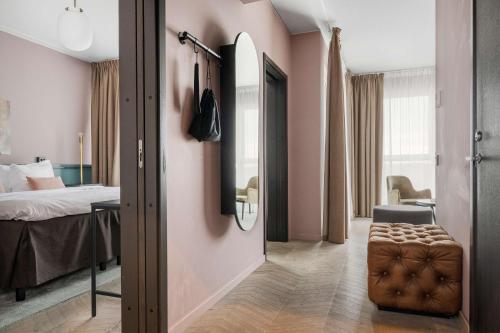 a corridor of a hotel room with a bedroom at Best Western Plus Hus 57 in Ängelholm