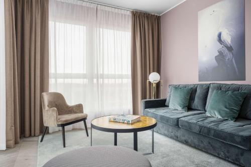 a living room with a couch and a table at Best Western Plus Hus 57 in Ängelholm