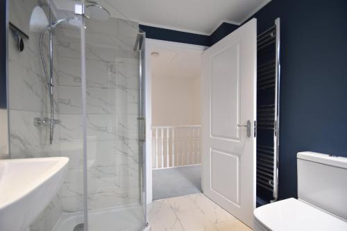 a bathroom with a shower and a glass shower door at Southbank in Rye