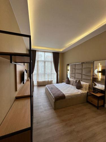 a bedroom with a bed and a large window at Berfinn Hotel Ortaköy in Istanbul