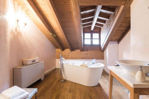 a bathroom with a white tub and a sink at Santa Giuliana Apartment in Como