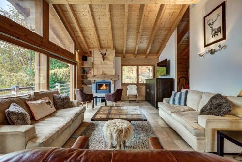 a living room with a couch and a fireplace at Chalet le Cerf in La Tzoumaz