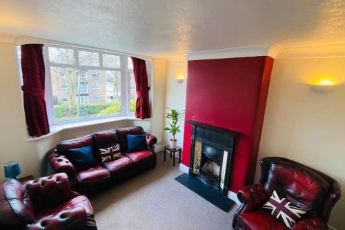 a living room with a couch and a fireplace at 3 BR Property in Prestwich 15 mins from Manchester City Centre Garden Free parking Superfast WIFI Netflix in Manchester