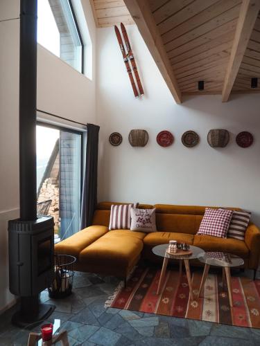 a living room with a couch and a fireplace at Owczarnia Tatry in Bukowina Tatrzańska