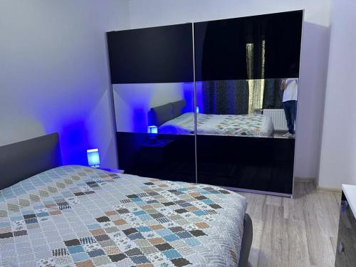 a bedroom with a bed and a large mirror at B&B Iulius in Cluj-Napoca