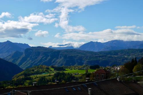 a view of mountains and a town in a valley at La Casa Suites Albaredo di Rotzo in Albaredo