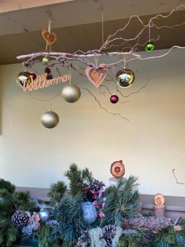 a christmas table with christmas trees and decorations at Landhaus Rosengartl Krimml in Oberkrimml