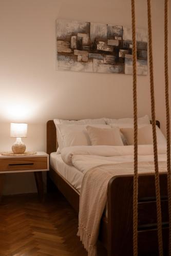 a bedroom with a swinging bed with a lamp on a table at 16DI in Kraljevo