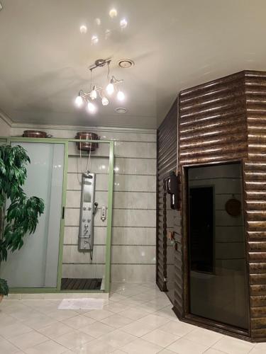 a shower in a room with a wall at Kamelot in Kyiv