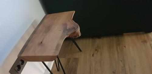 a wooden table sitting on top of a wooden floor at AppPrusnik in Ljubljana