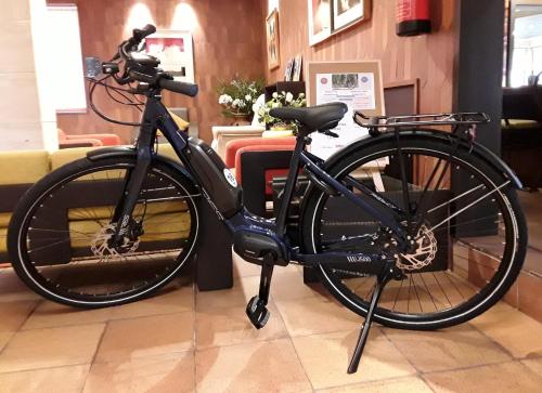 a black bike is parked in a store at Montemar in Llanes
