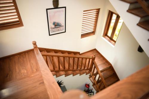 a wooden staircase in a house with two windows at Kingfisher Bamboo Garden Villa in Unawatuna