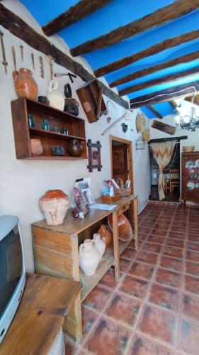 a living room with a tv and a tiled floor at Casa rural LA CRIVA in Crivillén