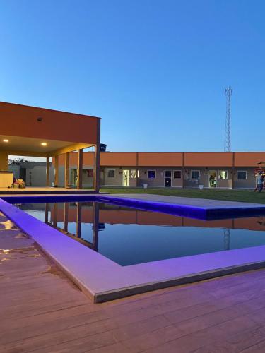 a swimming pool with blue lights on top of a building at Pousada Vila das Lagoas in Santo Amaro