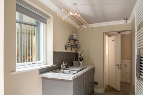 a kitchen with a sink and a window at Bryntirion Lodge in Y Felinheli