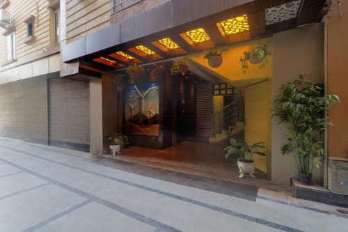 an entrance to a building with potted plants on it at FabExpress Ganpati 2 - Nr Siliguri Junction in Siliguri