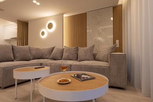 a living room with a couch and a table at LUX&EASY Acropolis Suites in Athens